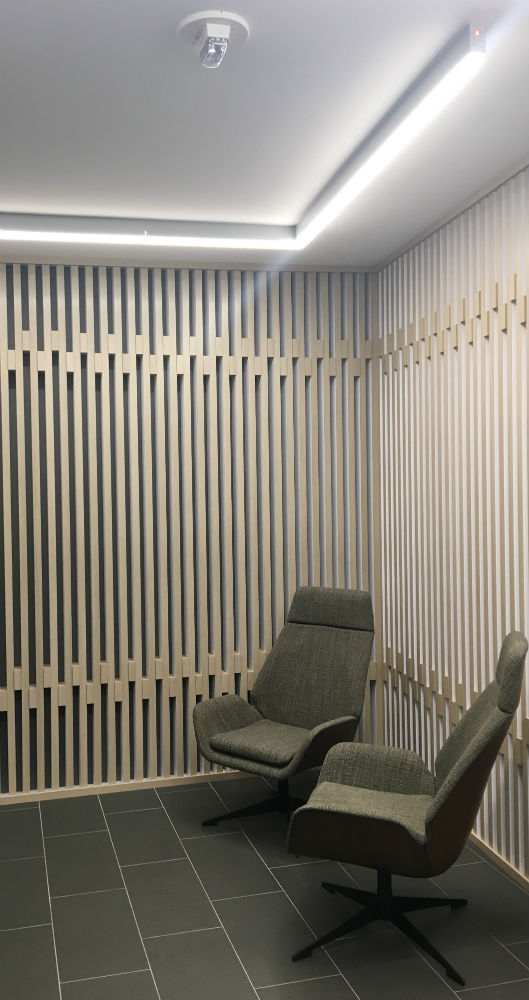 A room with two chairs and a wall